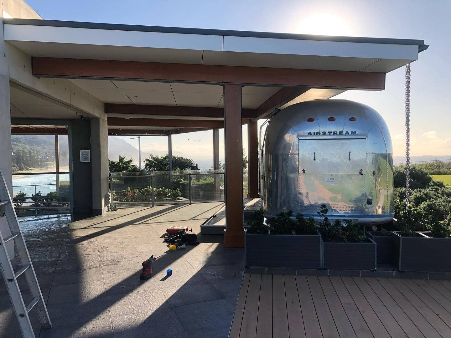A Silver Airstream Trailer is Parked Under a Canopy — LG Constructions in Thirroul, NSW