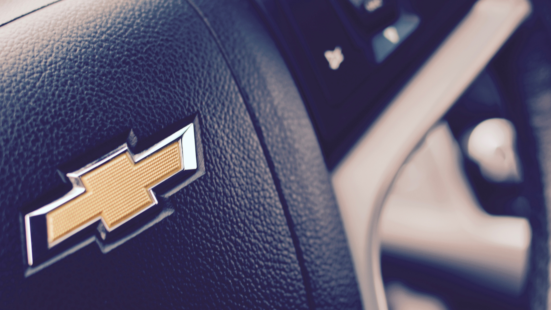 A close up of a chevrolet steering wheel