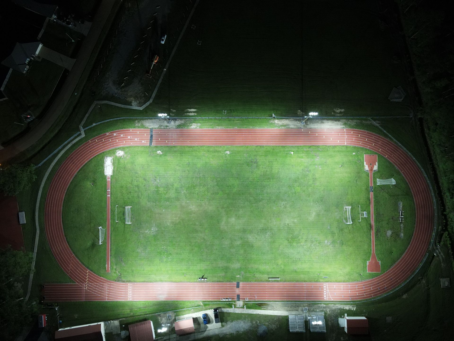 Drone image of Pearl River Highschool track illuminated by LED sports lighting.