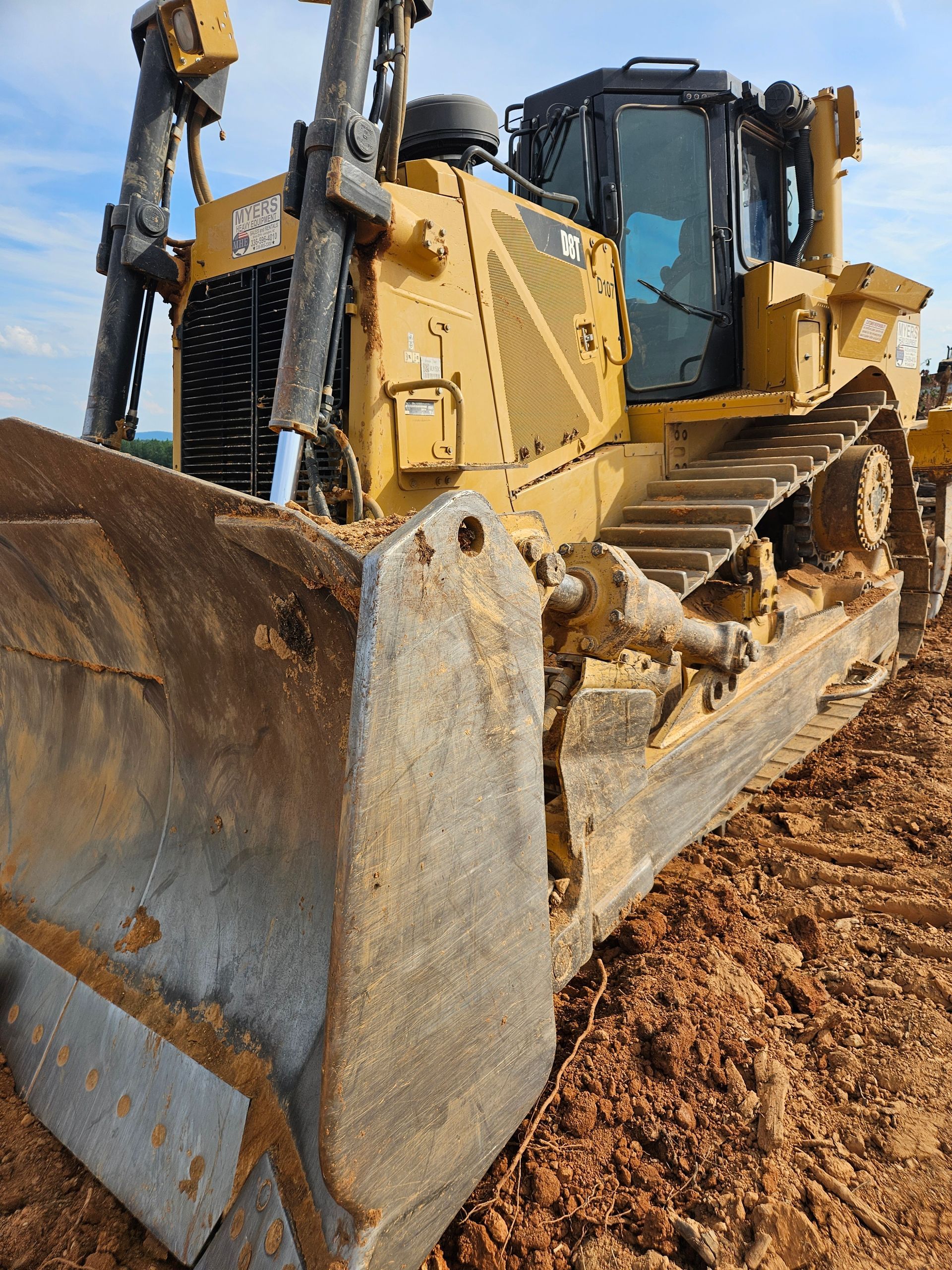 A bulldozer is sitting in the dirt on a construction site.  Ready for land clearing and land grading for site prep services in Statesville, NC