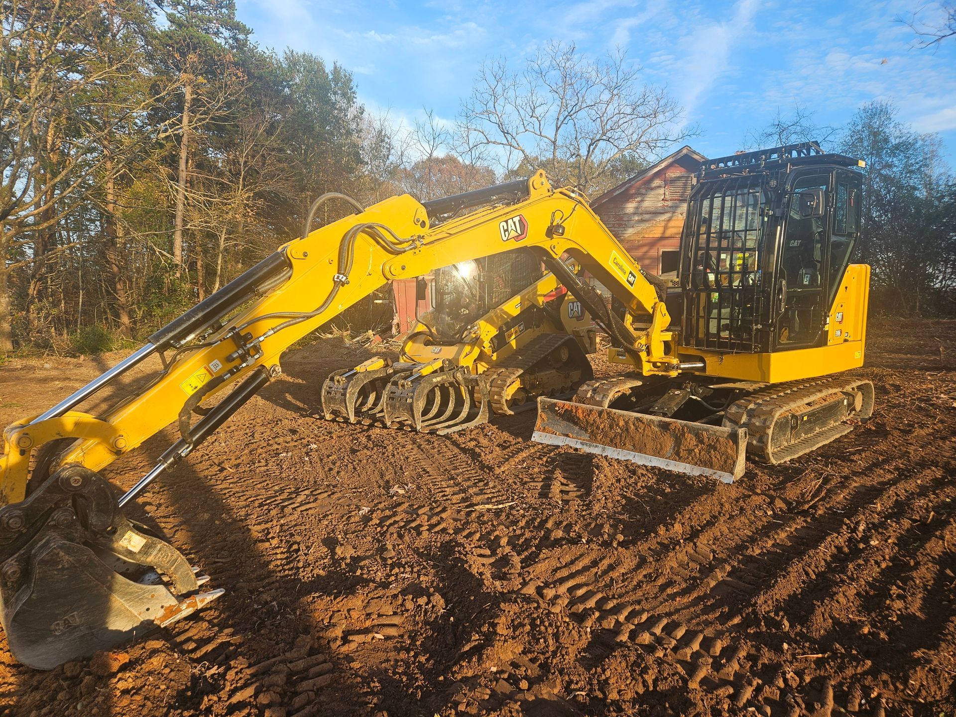 A yellow excavator is digging a hole in the dirt.