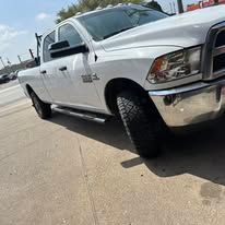 White pickup truck parked outdoors, sunny day.
