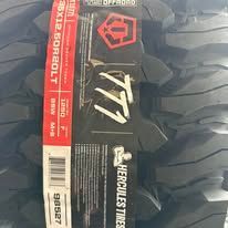 Close-up of a stack of black Hercules Tires, with a red and white label visible.