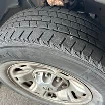 Close-up of a car tire with a silver rim.