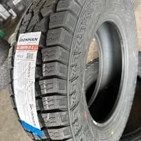Black tire with a visible brand label on its side.