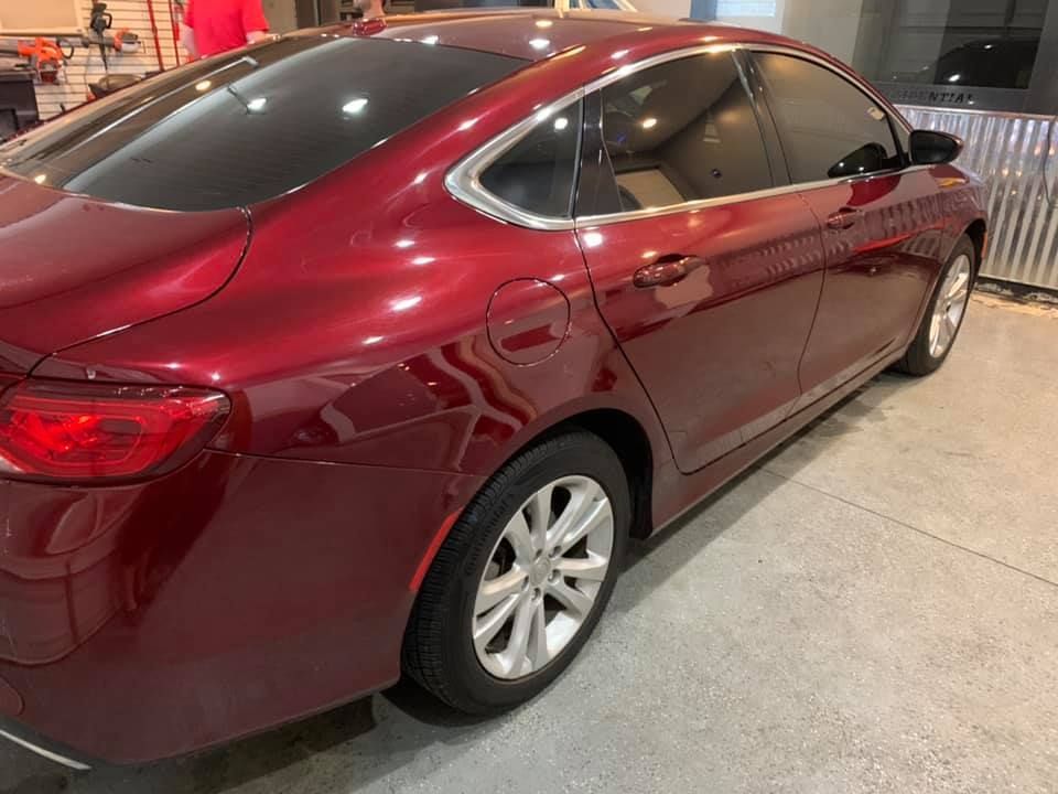 A red car is parked in a garage.