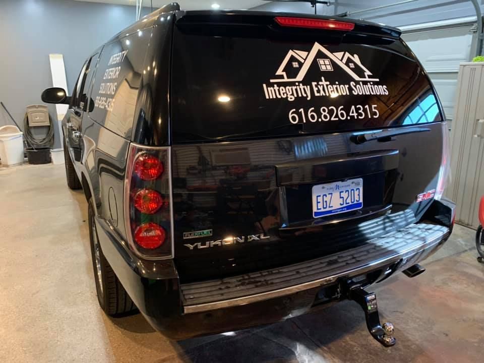A black suv is parked in a garage.