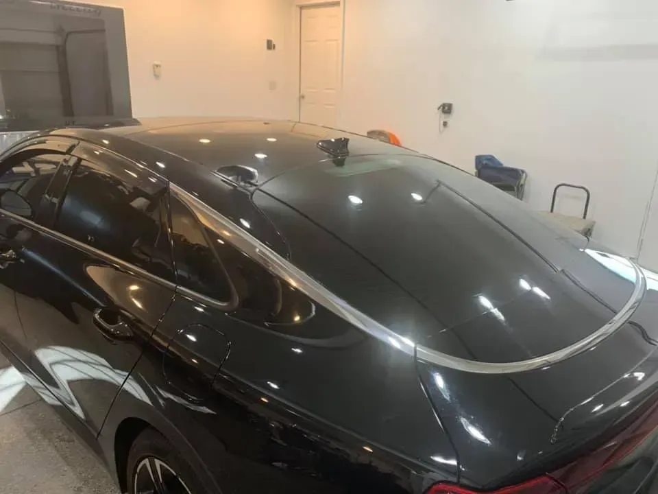 A black car is parked in a garage.
