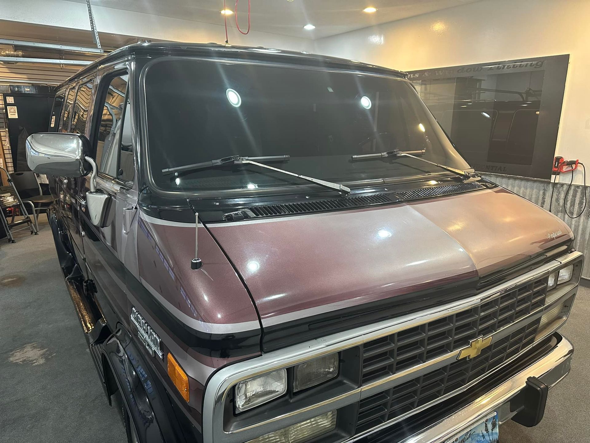 A purple van is parked in a garage.