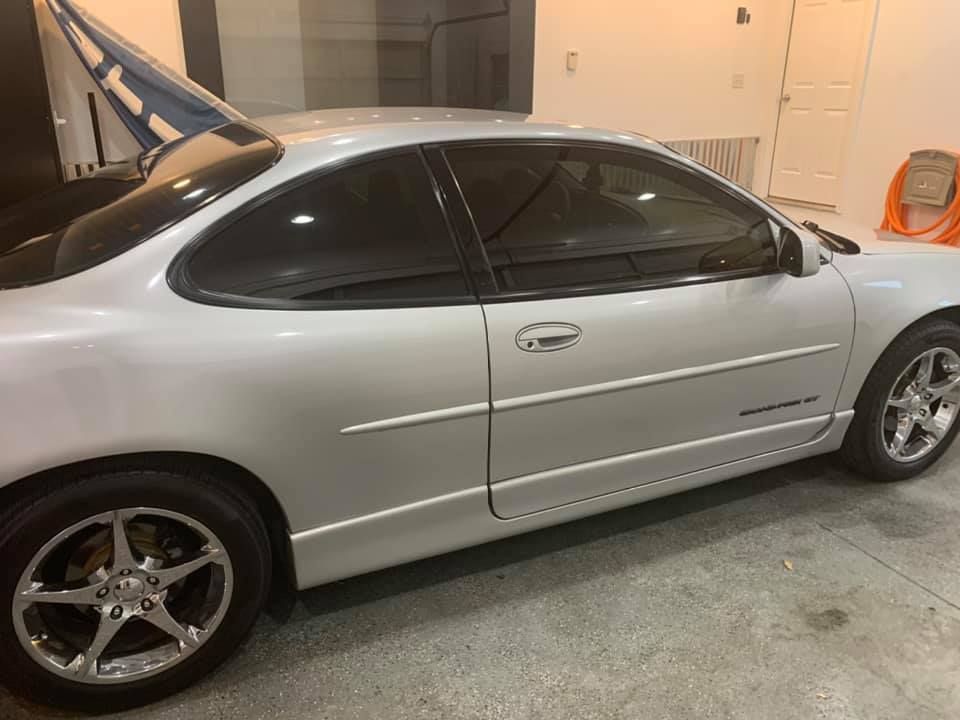 A silver car is parked in a garage.