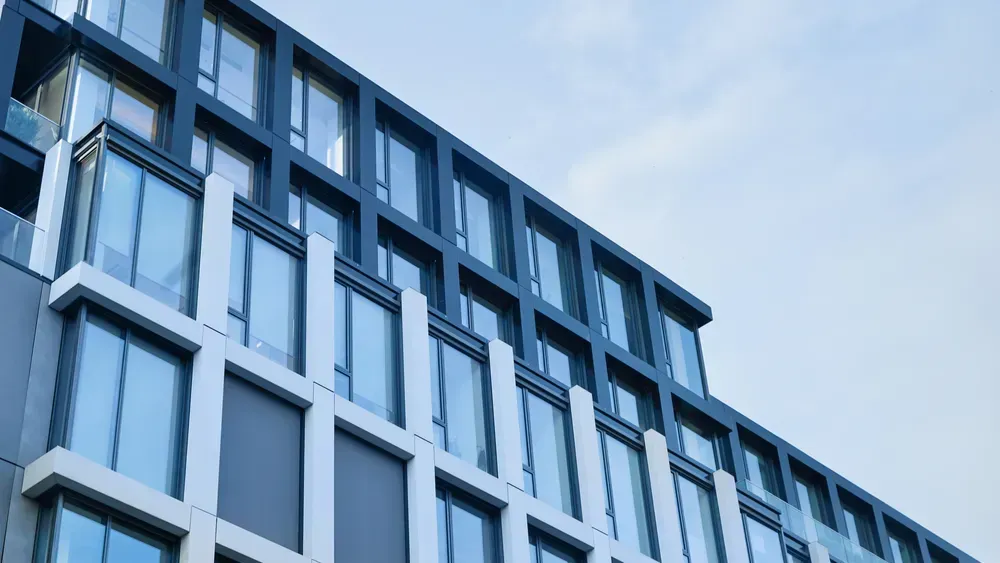 A large building with a lot of windows against a blue sky.