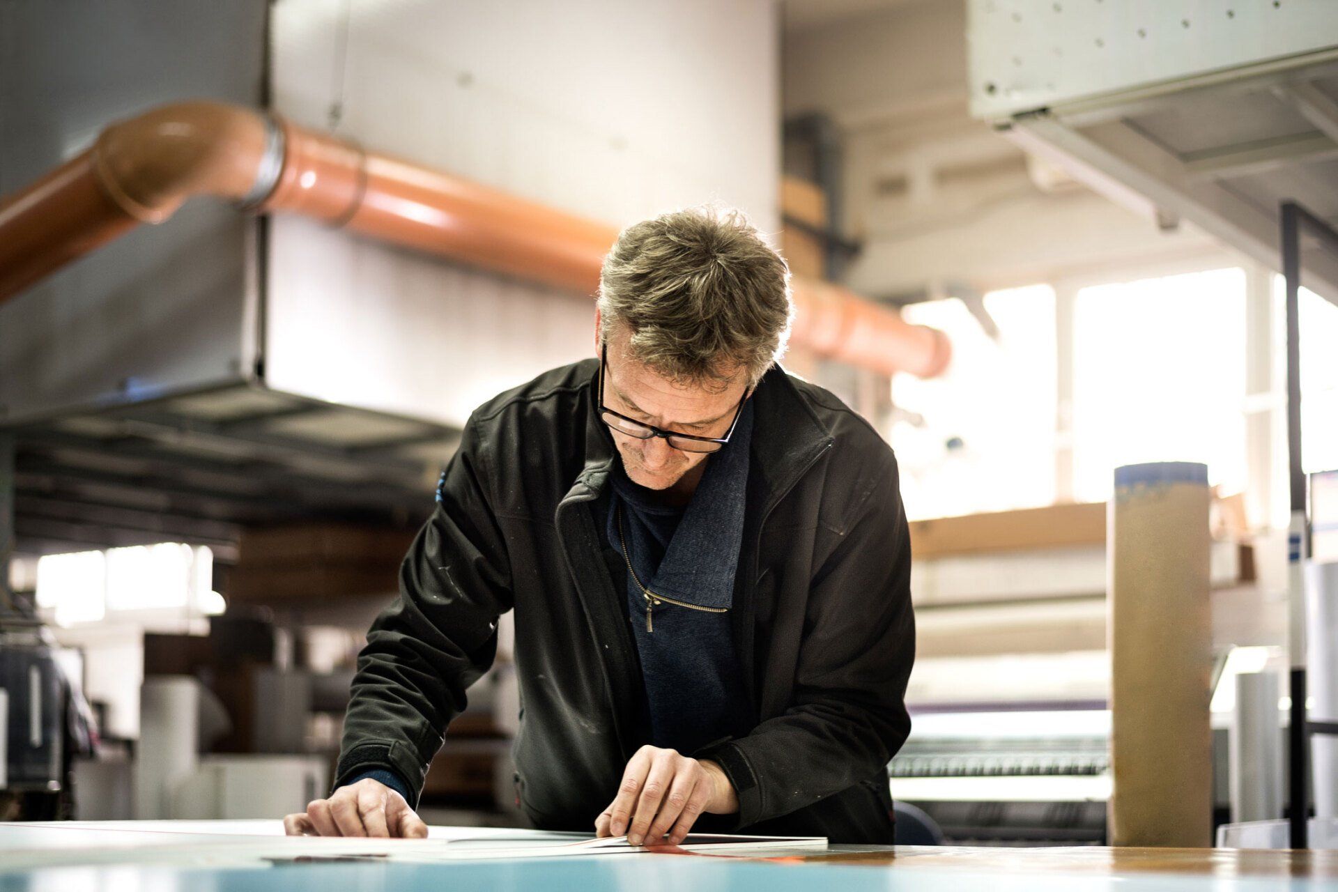 Man Checking Printer — Hobart, TAS — Labelpress Printing Services Pty Ltd