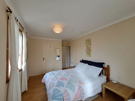 bedroom with large bed and white bedlinen