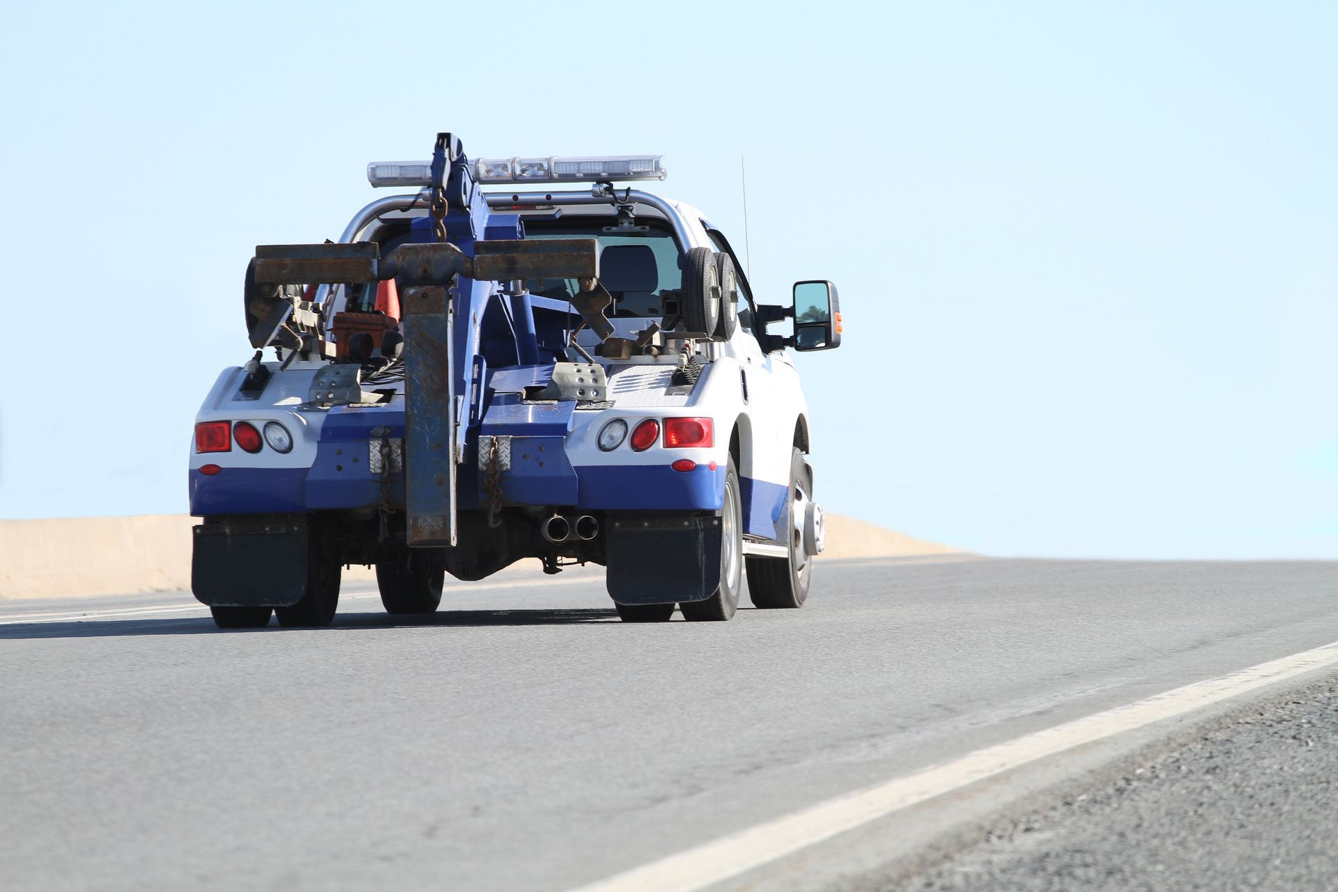 A tow truck on the road.
