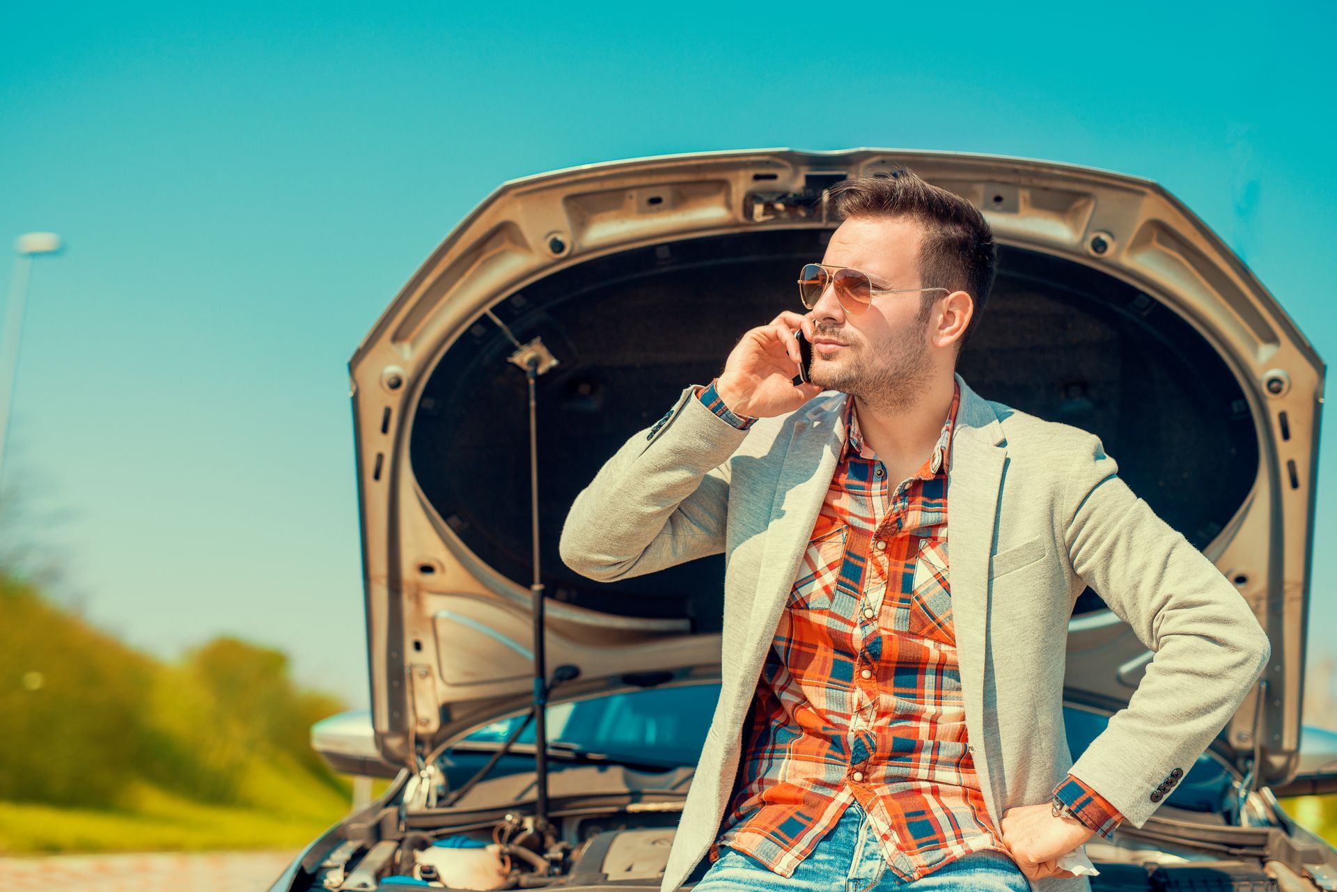 a person in front of his car needing an Accident Towing