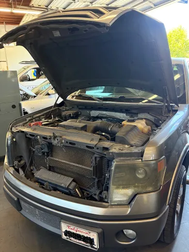 SUV with hood up to see engine in our garage in Belmont, CA | Spiteri's Complete Auto Service
