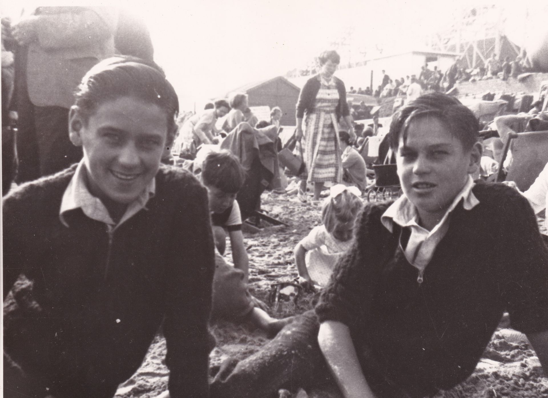Black and white photo of two young men on a beach in the United Kingdom.