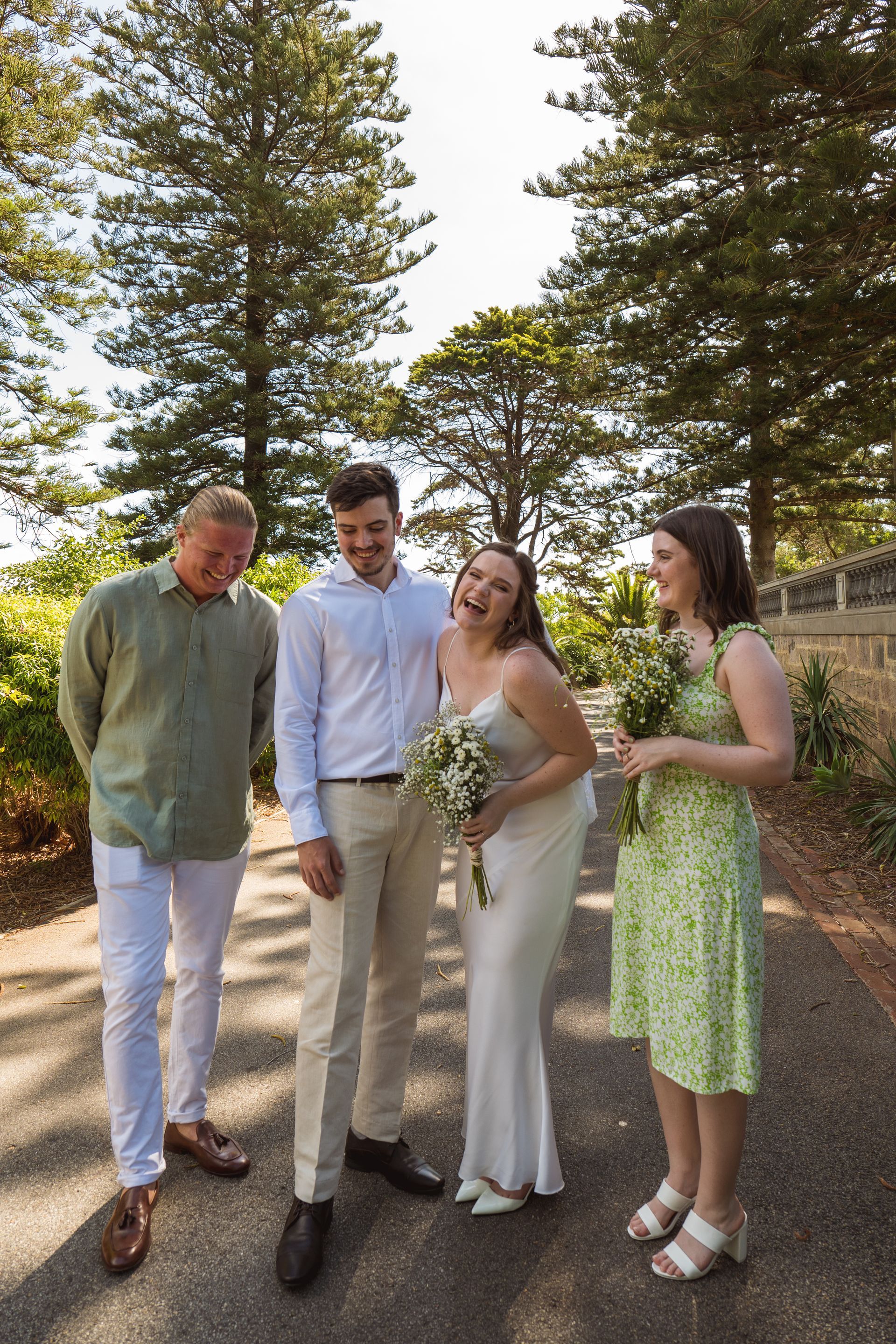 A group of people standing next to each other on a path.