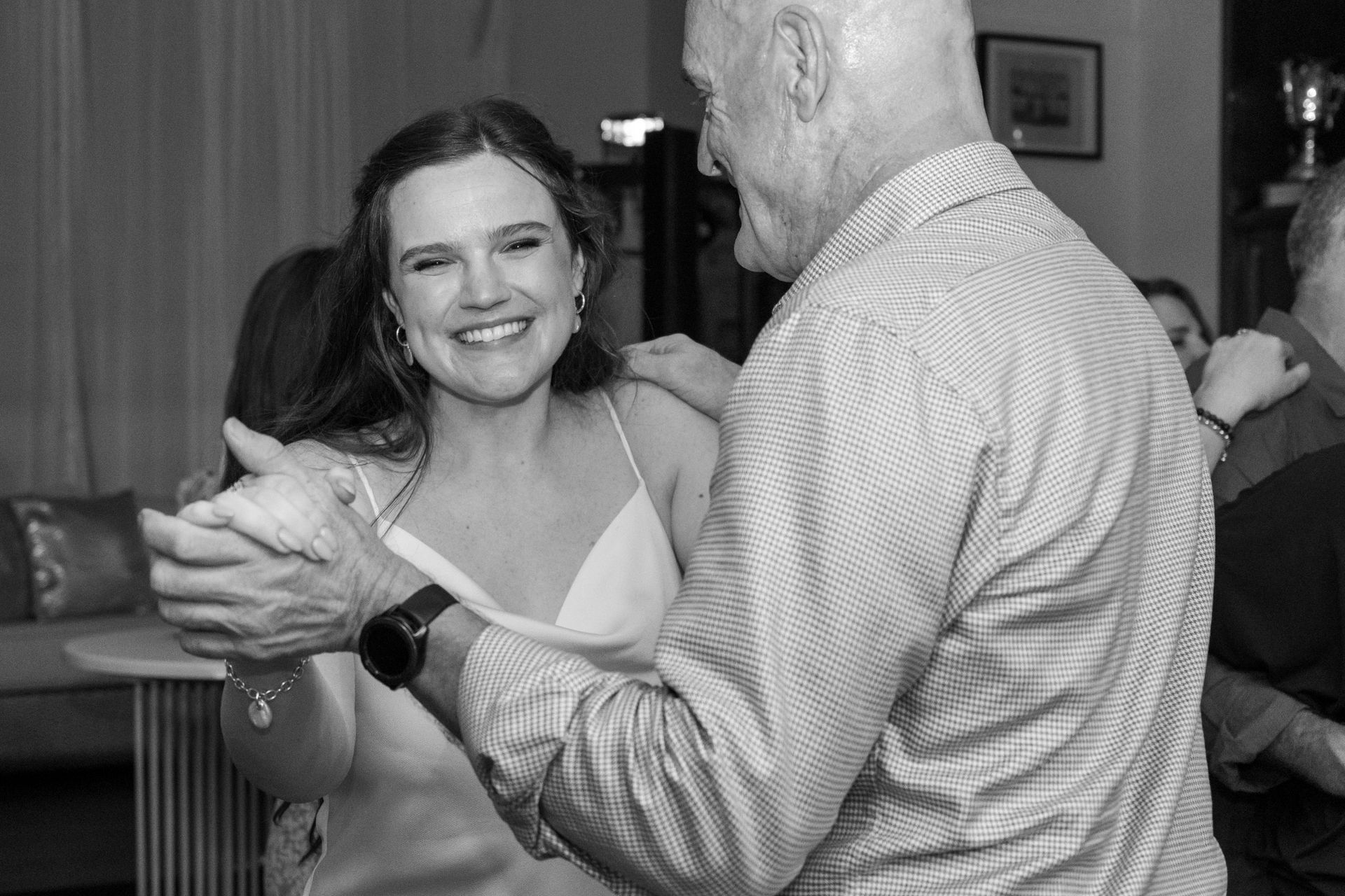 A man and a woman are dancing together in a black and white photo.