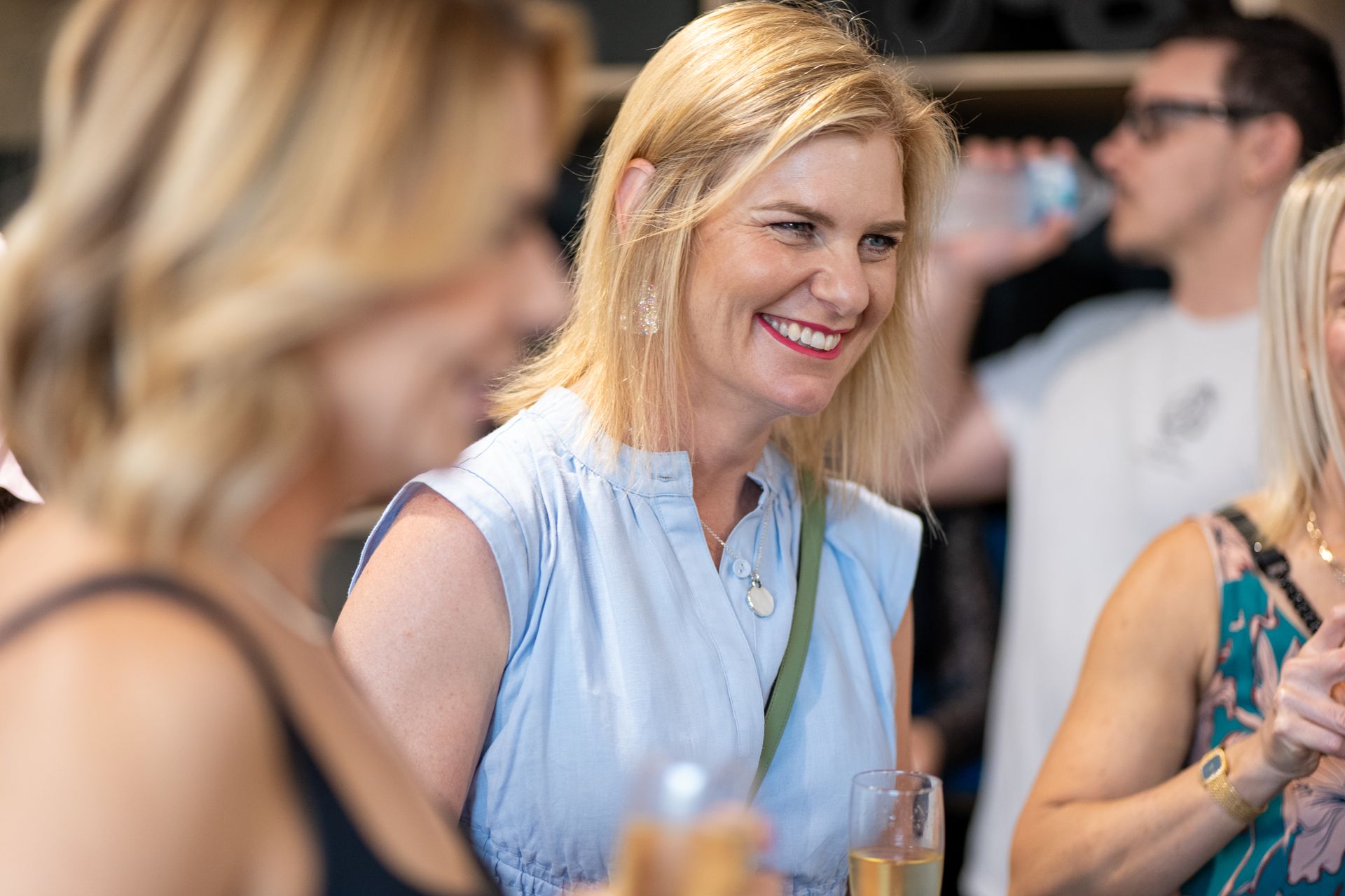 A group of women are talking to each other at a party.