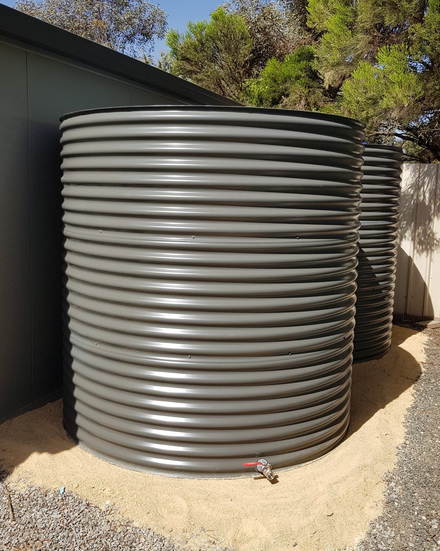 Two White Water Tanks Are Stacked on Top of Each Other — Maitland Sheet Metal in Rutherford, NSW