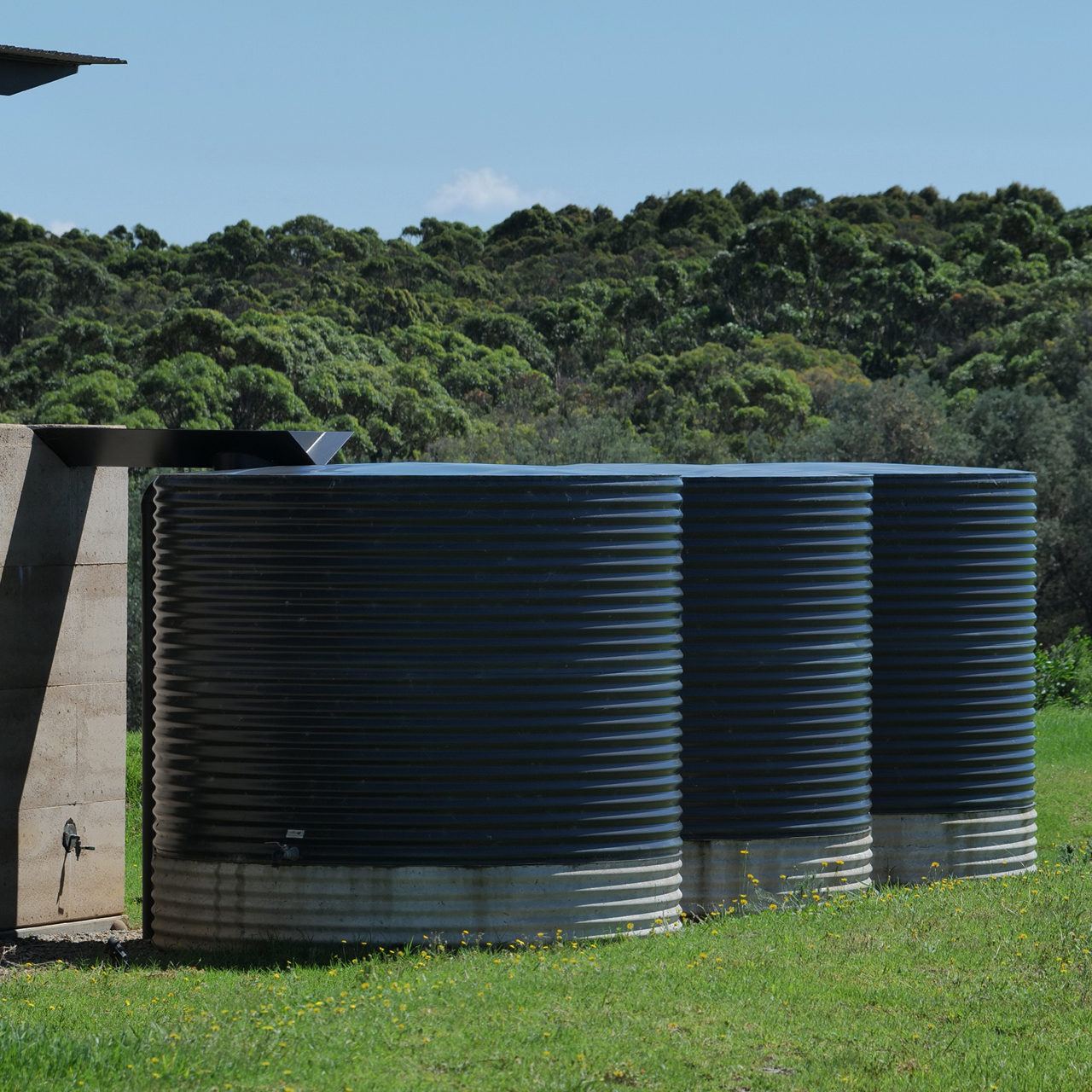 A Large Gray Tank Is Sitting in The Middle of A Room Filled with Pipes — Maitland Sheet Metal in Rutherford, NSW