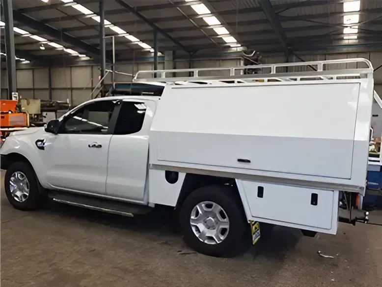 A White Truck with A Canopy Is Parked in A Warehouse — Maitland Sheet Metal in Rutherford, NSW