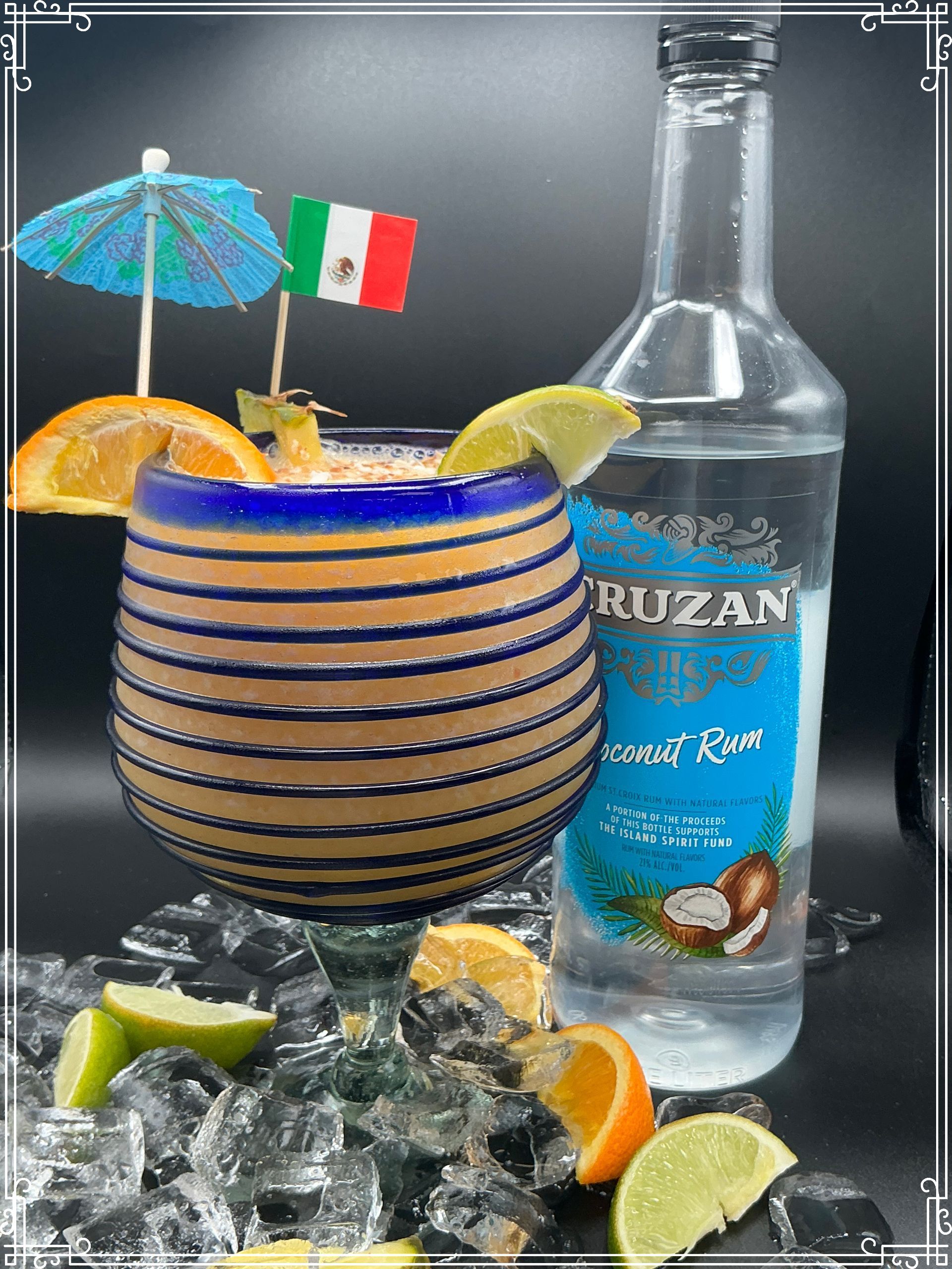 Cocktail in blue-striped glass, with coconut rum bottle, orange slices, and Mexican flag.
