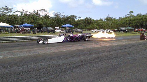 A purple and white race car with flames coming out of it