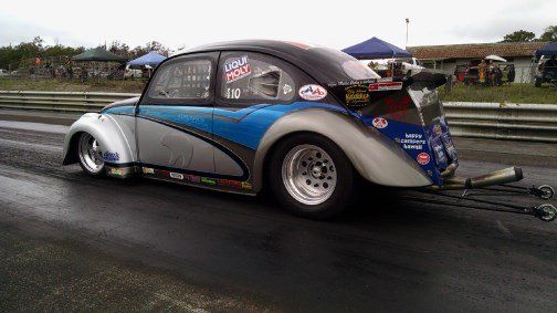 A race car is parked on the side of the road.