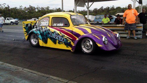 A yellow and purple car with the number 2001 on the side