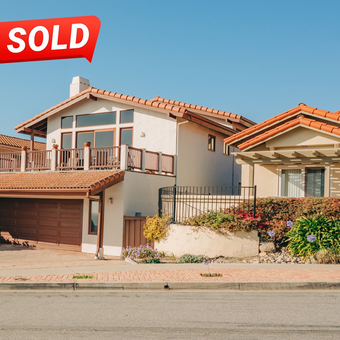 A two house with a sold sign above it