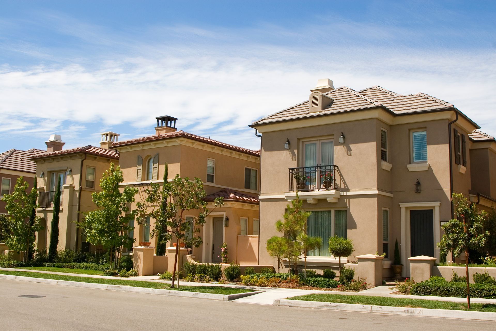 A row of houses on a sunny day with a blue sky