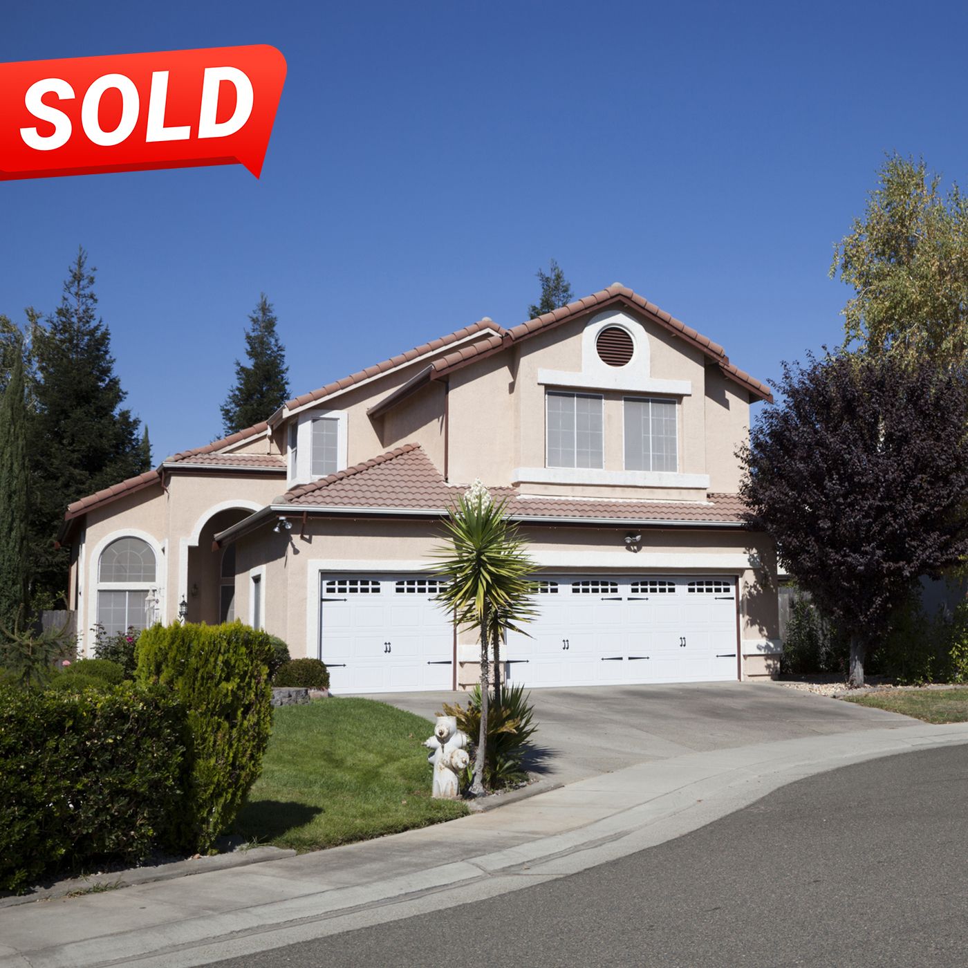 A large house with a sold sign on it