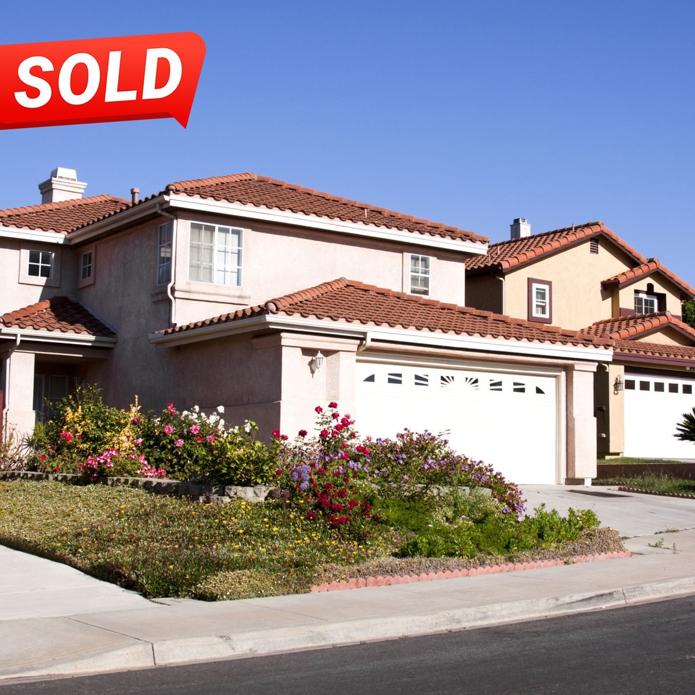 A white house with a sold sign in front of it