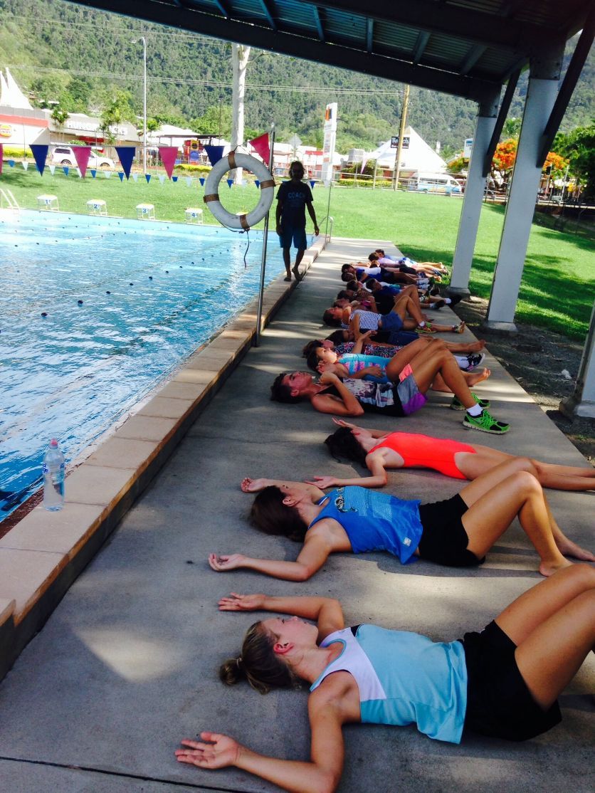 Adult And Children Lying Beside The Pool — Swim Training In Cannonvale, QLD