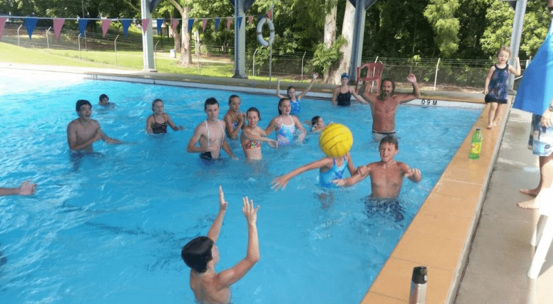 Adult And Children Playing Ball In Pool — Swim Training In Cannonvale, QLD