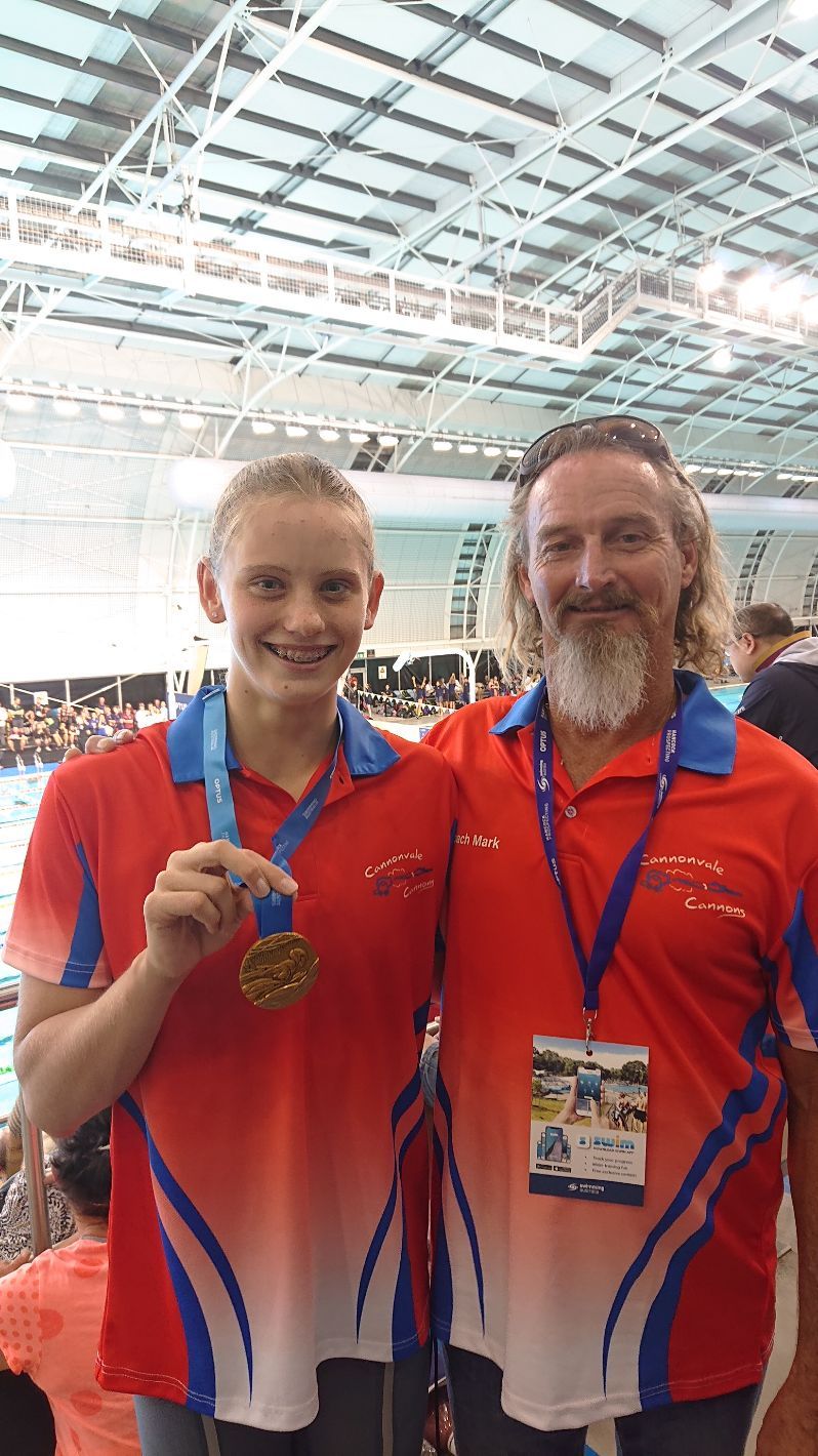 Miki And Mark With Their National Shirts And Medal — Swim Training In Cannonvale, QLD