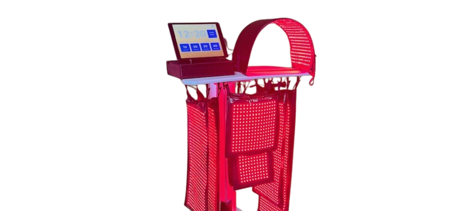 Person receiving body treatment with device on abdomen; person wearing pink gloves.