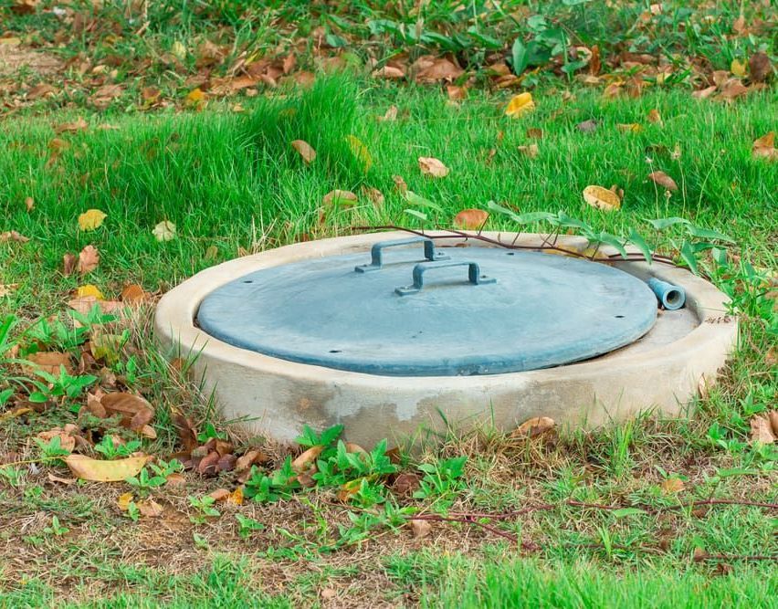 A Septic Tank Is Sitting In The Middle Of A Lush Green Field — All Hours Vac Truck In Lakes Creek, QLD