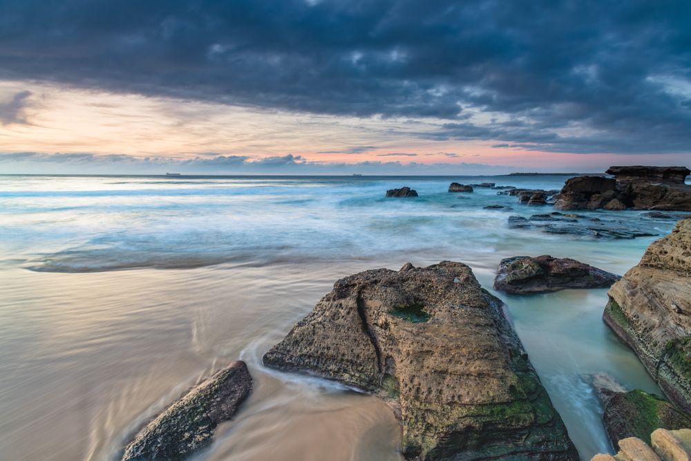A Long Exposure Photo Of A Rocky Beach At Sunset — All Hours Vac Truck In The Caves, QLD