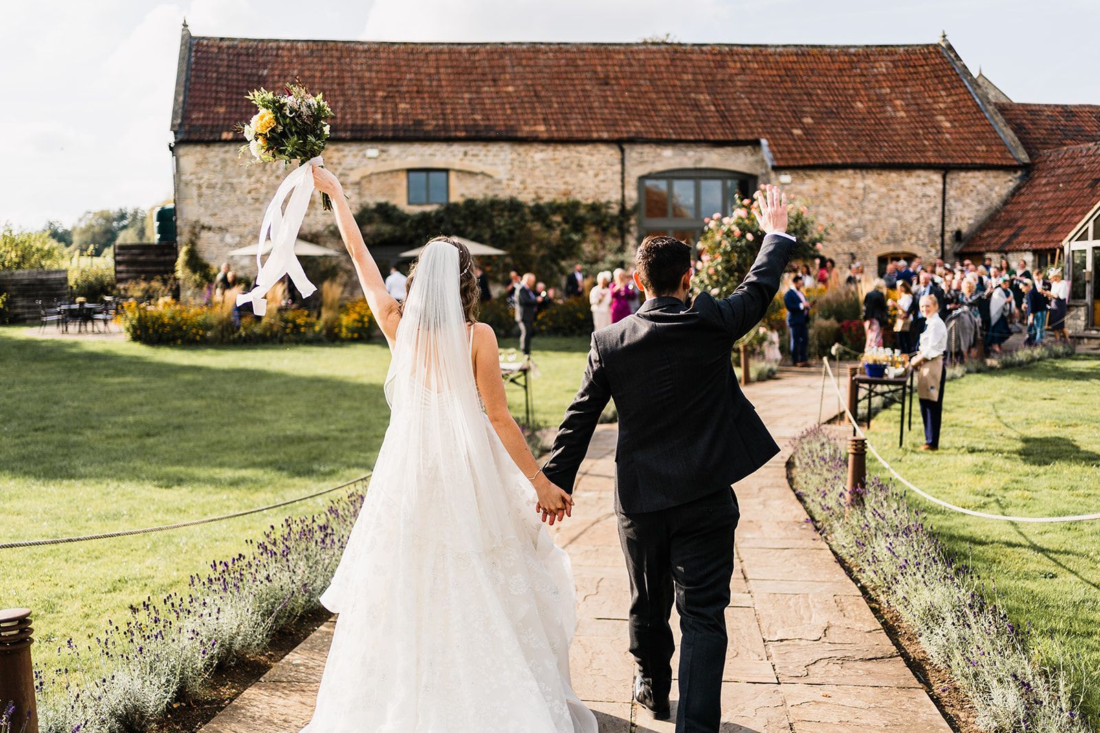 a bride and groom are walking through a tunnel of sparklers .