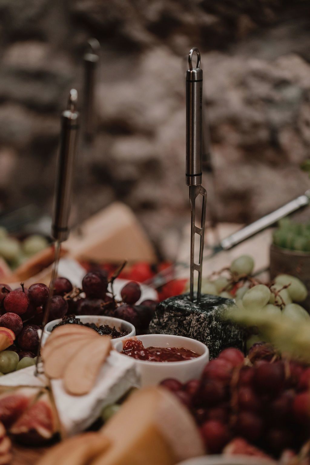 A table topped with a variety of fruits and cheeses.