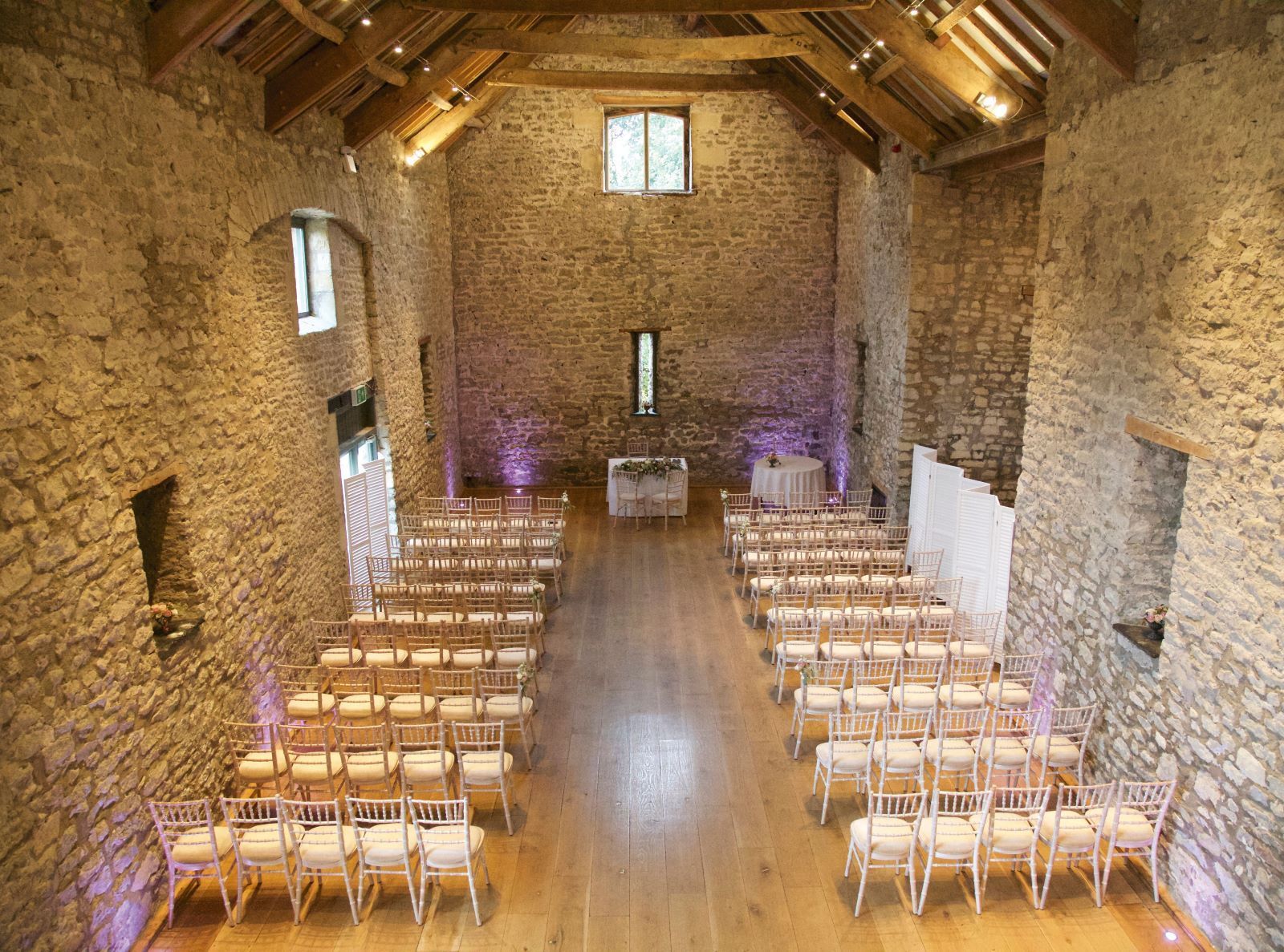 A large room with rows of chairs and a wooden floor.