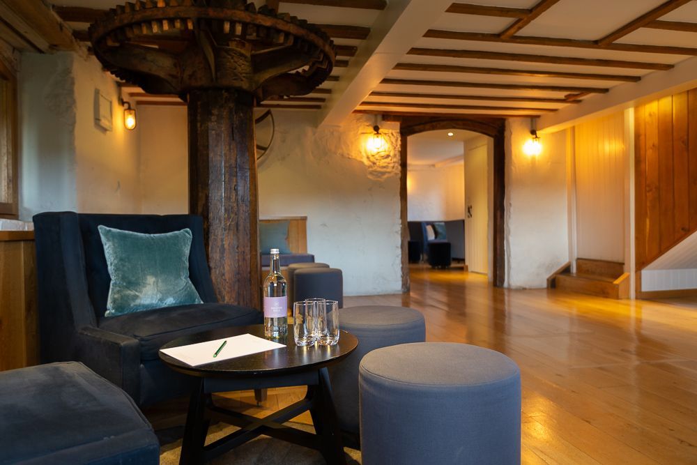 There is a table with a bottle of water on it in the middle of the room.