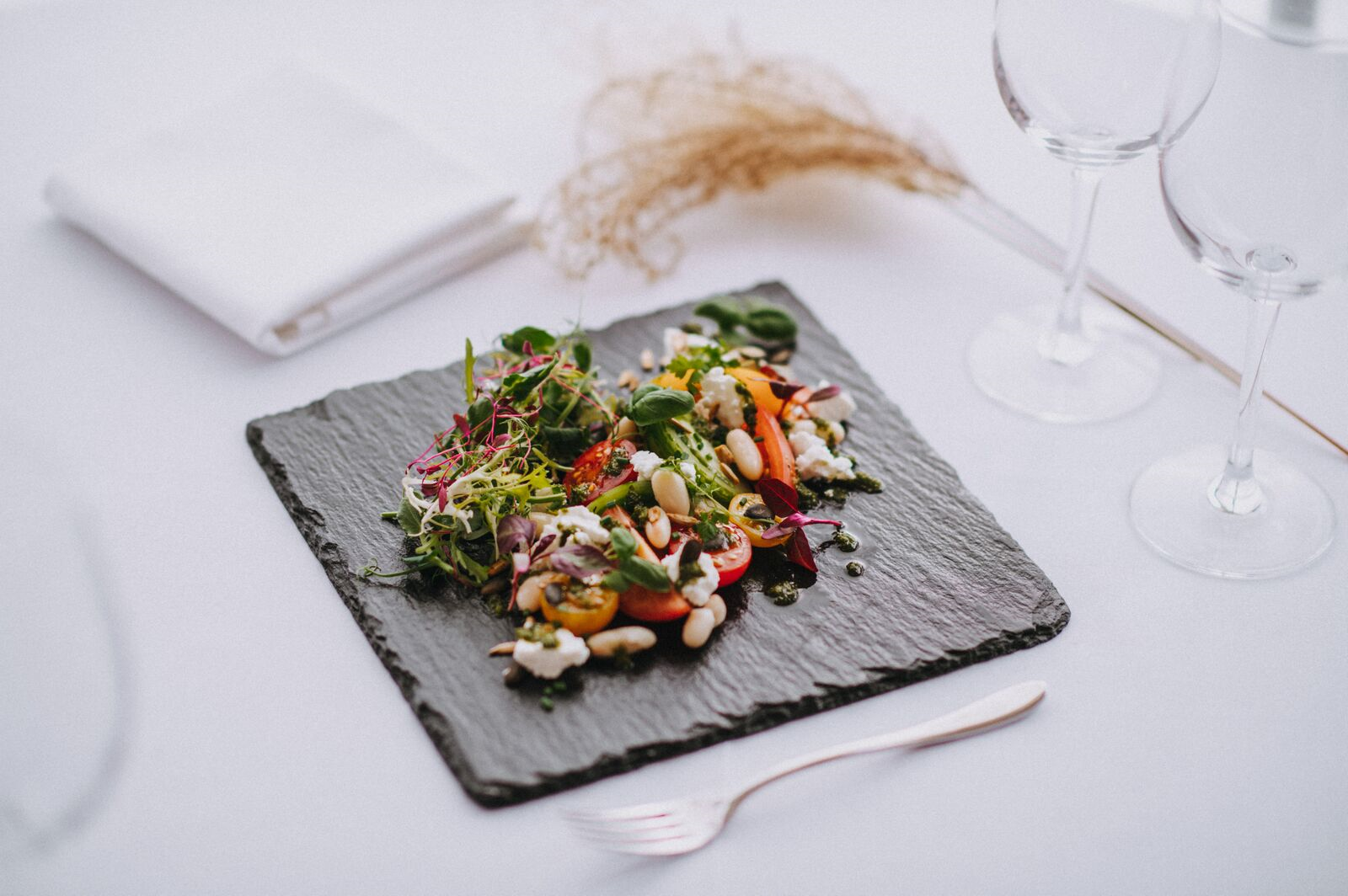 a white plate topped with a piece of food on a table .