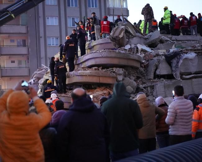 Rescuers atop a collapsed building in Turkey