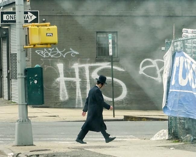 A Jewish man walks in Brooklyn, NY