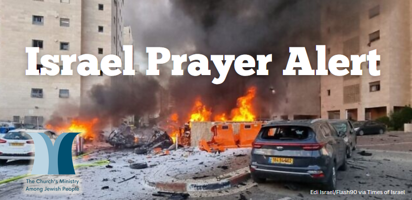 Cars and buidlings burn after a rocket strike in Israel