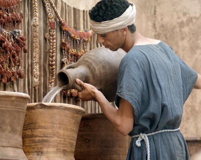 A man fills purifications jars with water